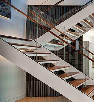 A staircase with glass railingsAI-generated content may be incorrect.