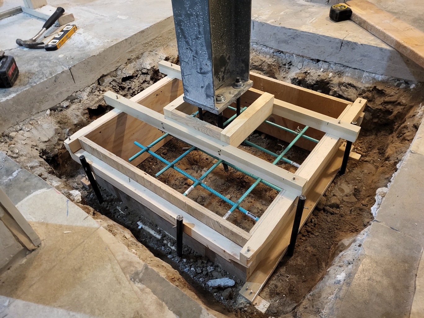Construction photo showing foundation for interior steel beam