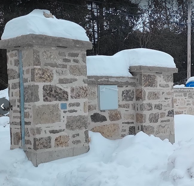 A stone structure covered in snowAI-generated content may be incorrect.