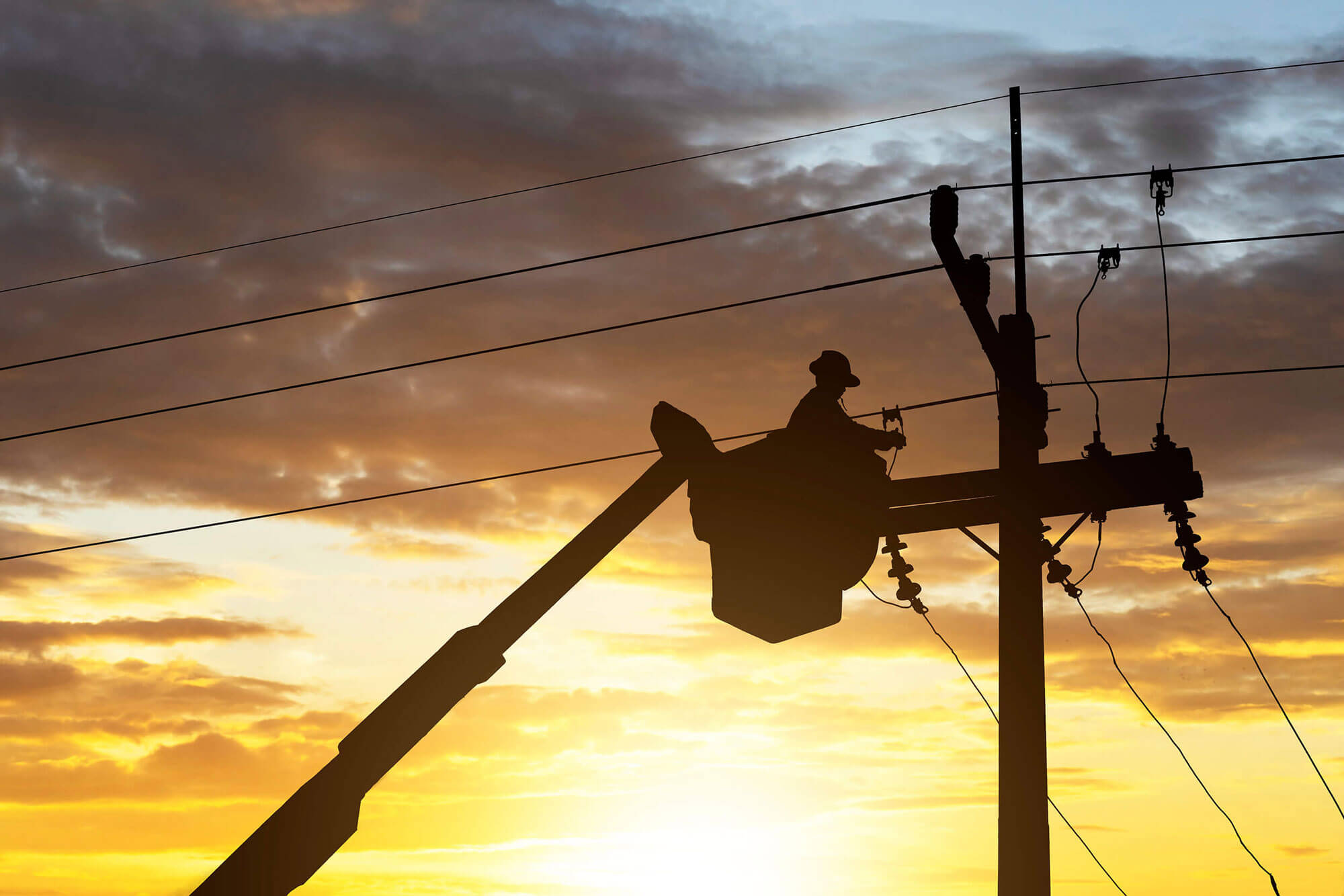 Image of technician working on power lines 