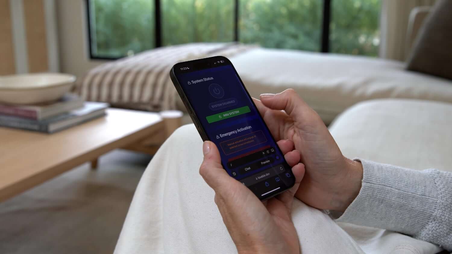 The Sonic Fire Tech Alert App on a phone, which provides remote monitoring, instant fire alerts, and control of the SFT system