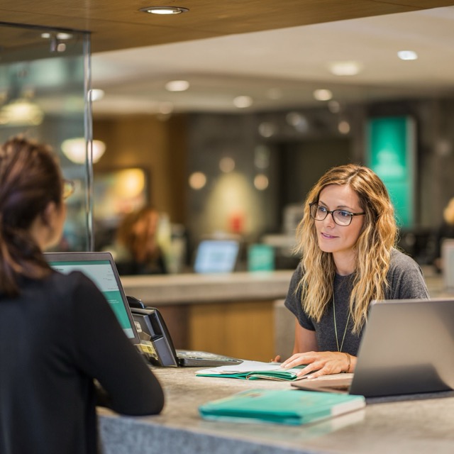 Bank branch representative guided by AI-powered coaching assistant