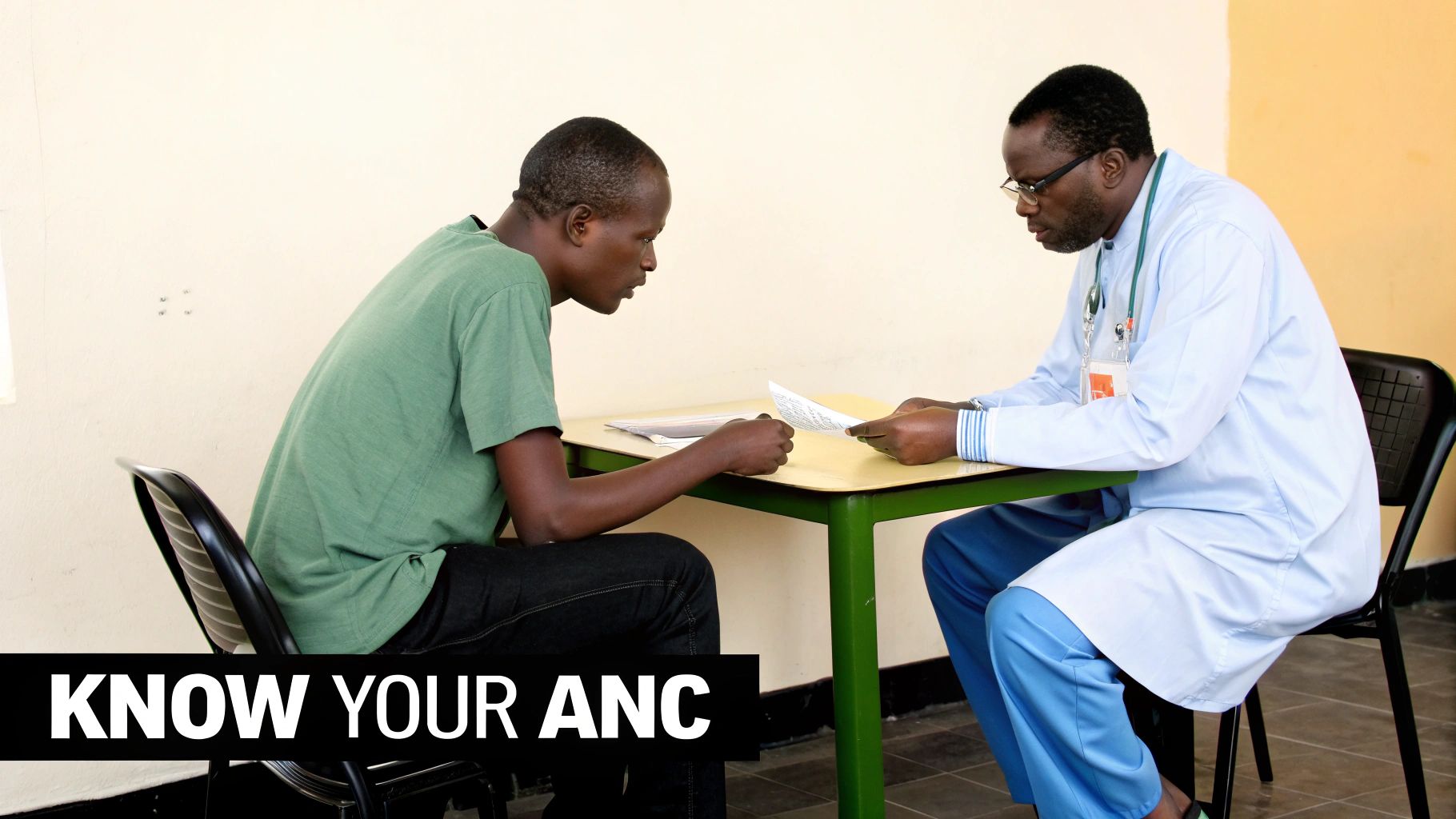 A doctor and patient discuss documents across a table during a medical consultation.