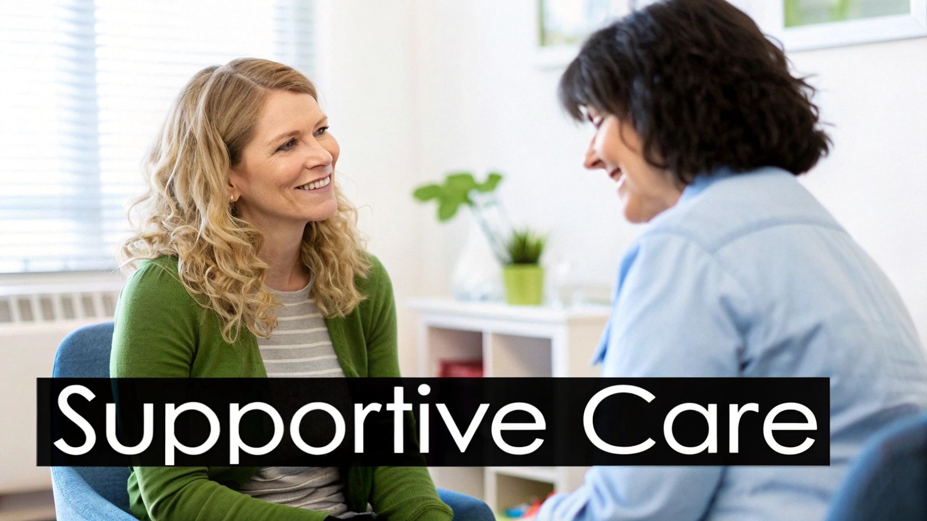 Two smiling women engaging in conversation, representing a supportive care session or counseling.