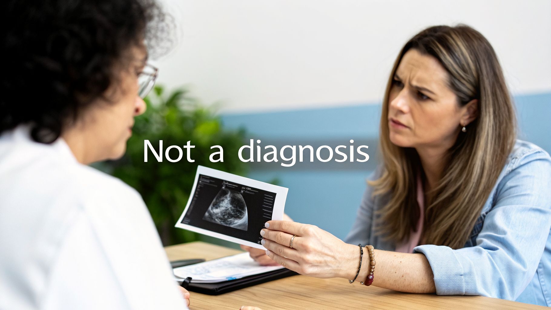 A concerned patient holds an ultrasound image, discussing results with a doctor in a medical consultation.