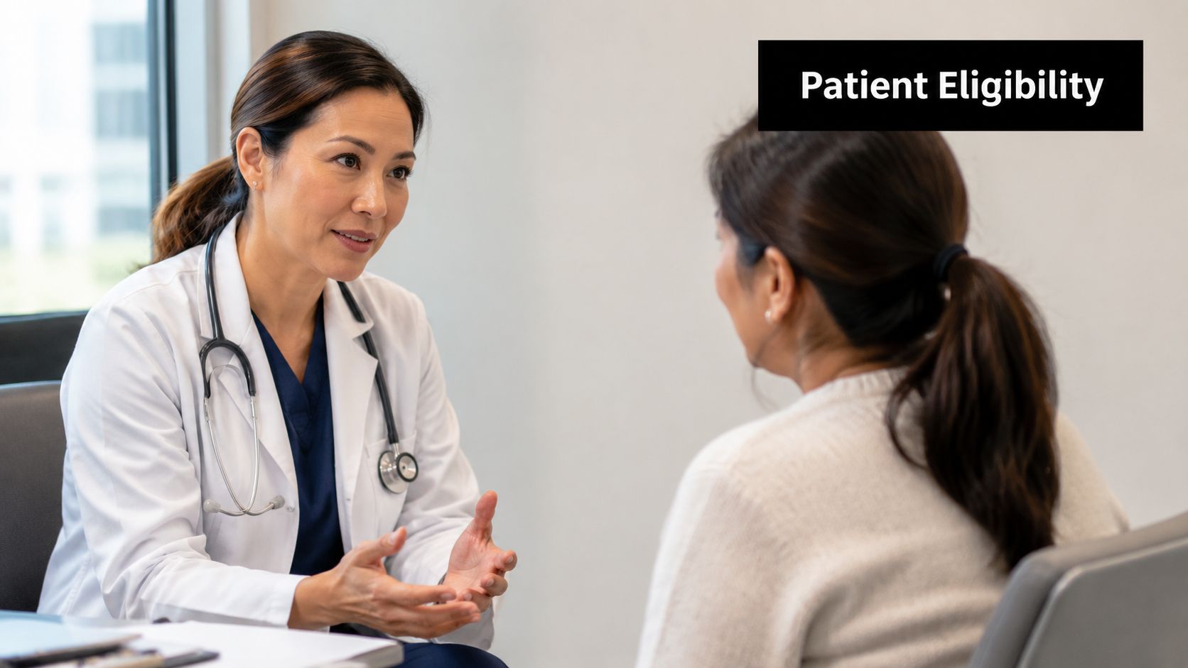 A female doctor in a white coat consulting with a female patient in a medical office setting.
