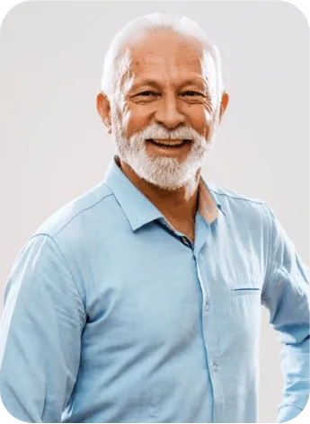 Elderly person in a blue shirt, standing with hands on hips.