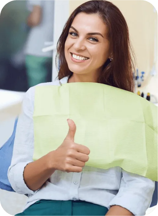 a woman sitting in a chair giving a thumbs up