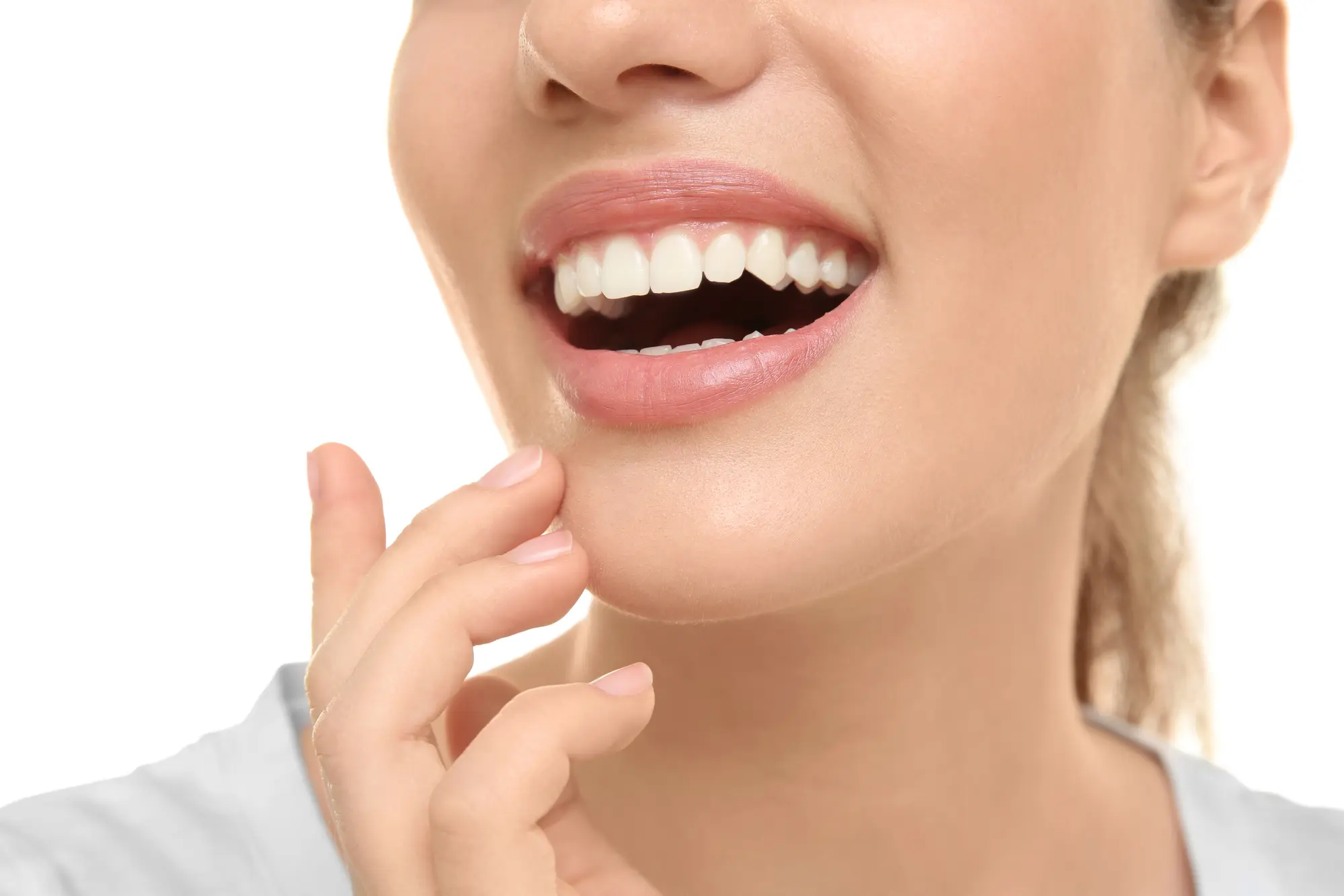 woman smiling and touching her chin