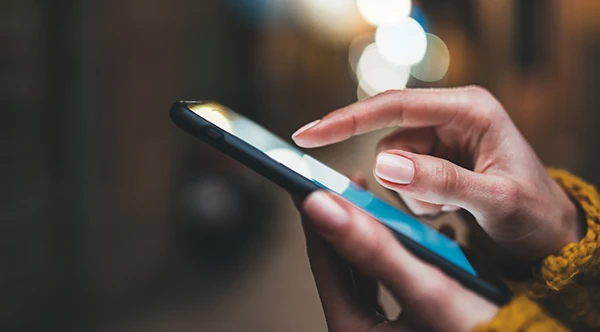 person's hand touching phone screen