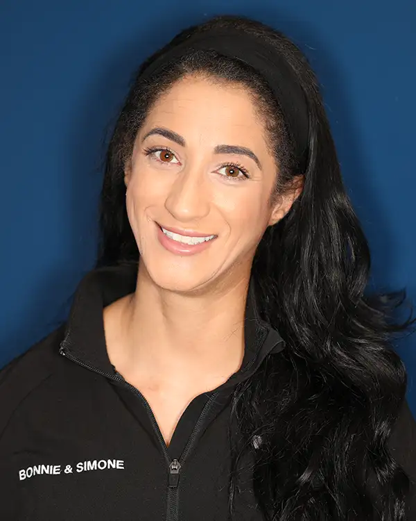 curly haired woman smiling for headshot