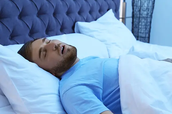 man snoring in bed