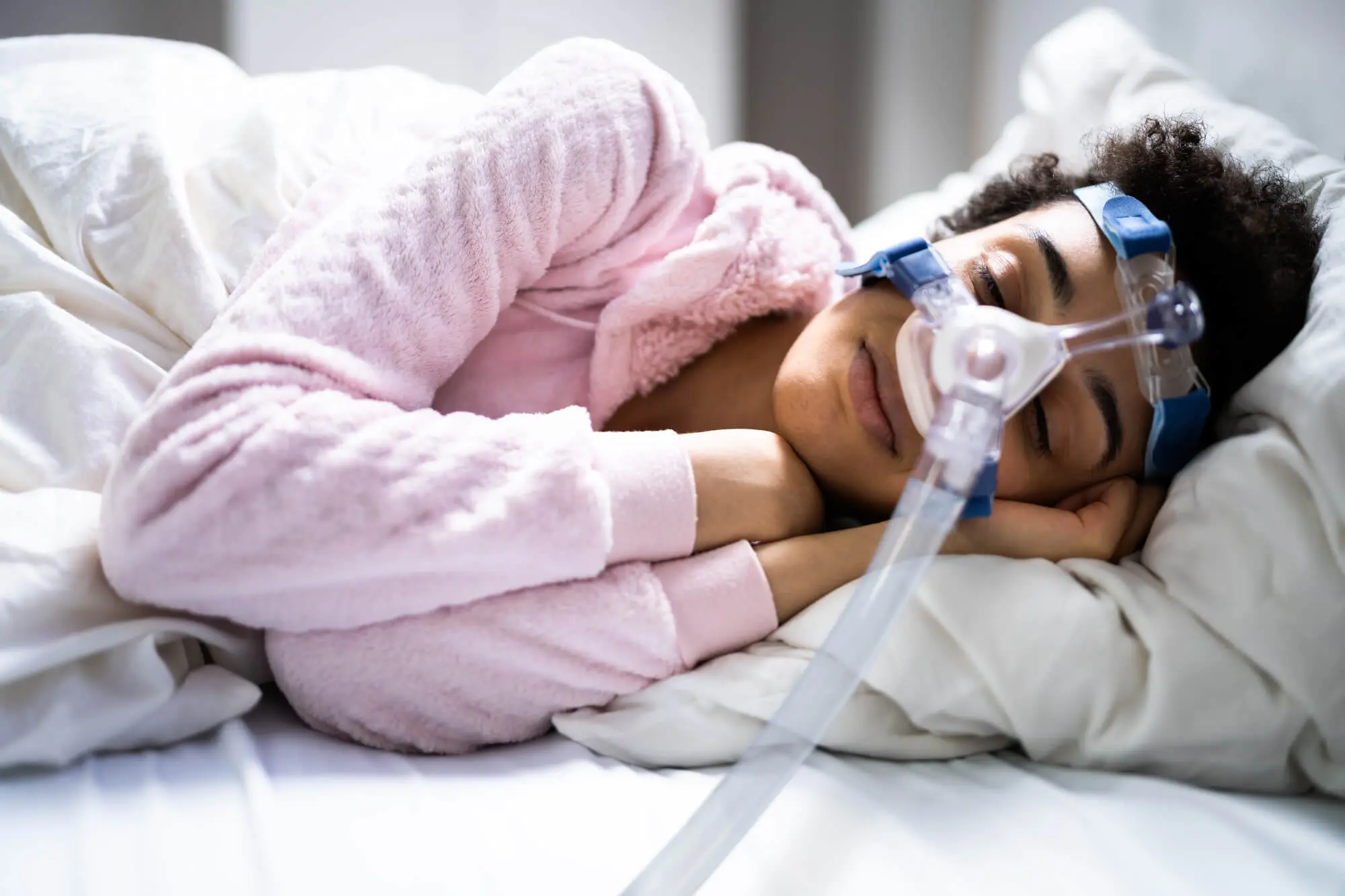 woman sleeping with CPAP mask