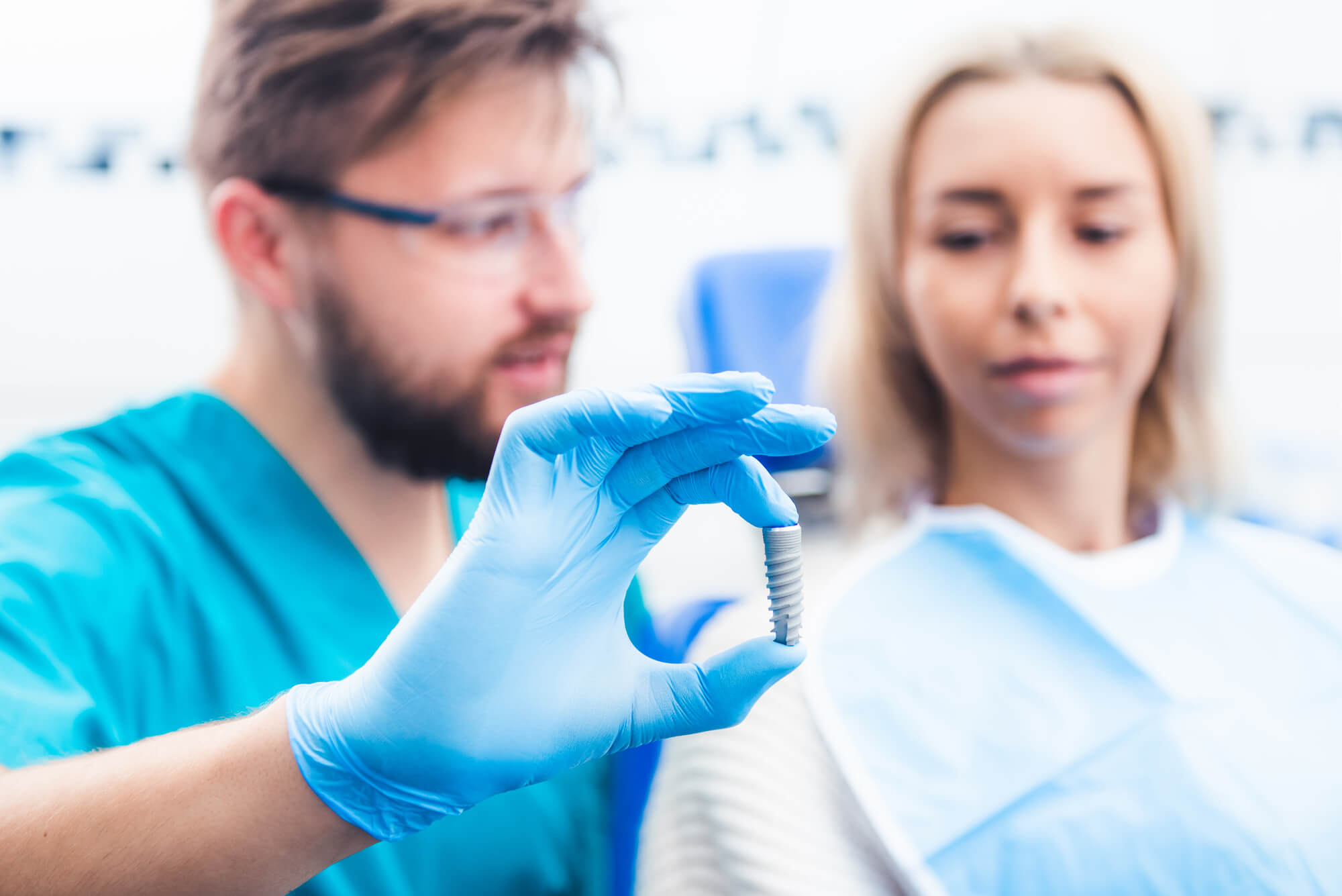 dentist explaining the full arch dental implants chesapeake procedure