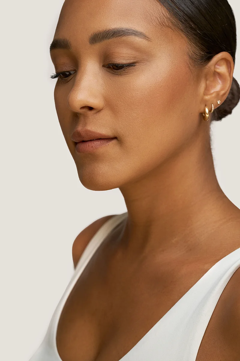 Young woman with smooth skin and balanced facial volume. 