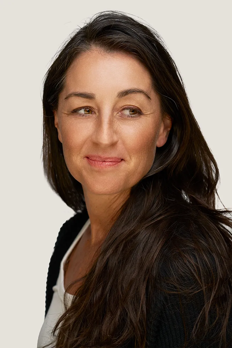 Middle-aged woman with refreshed skin balanced cheek volume. 