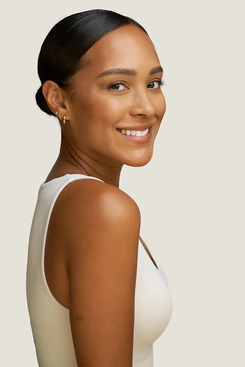 Young woman with youthful, smooth skin with no visible fine lines or wrinkles. 