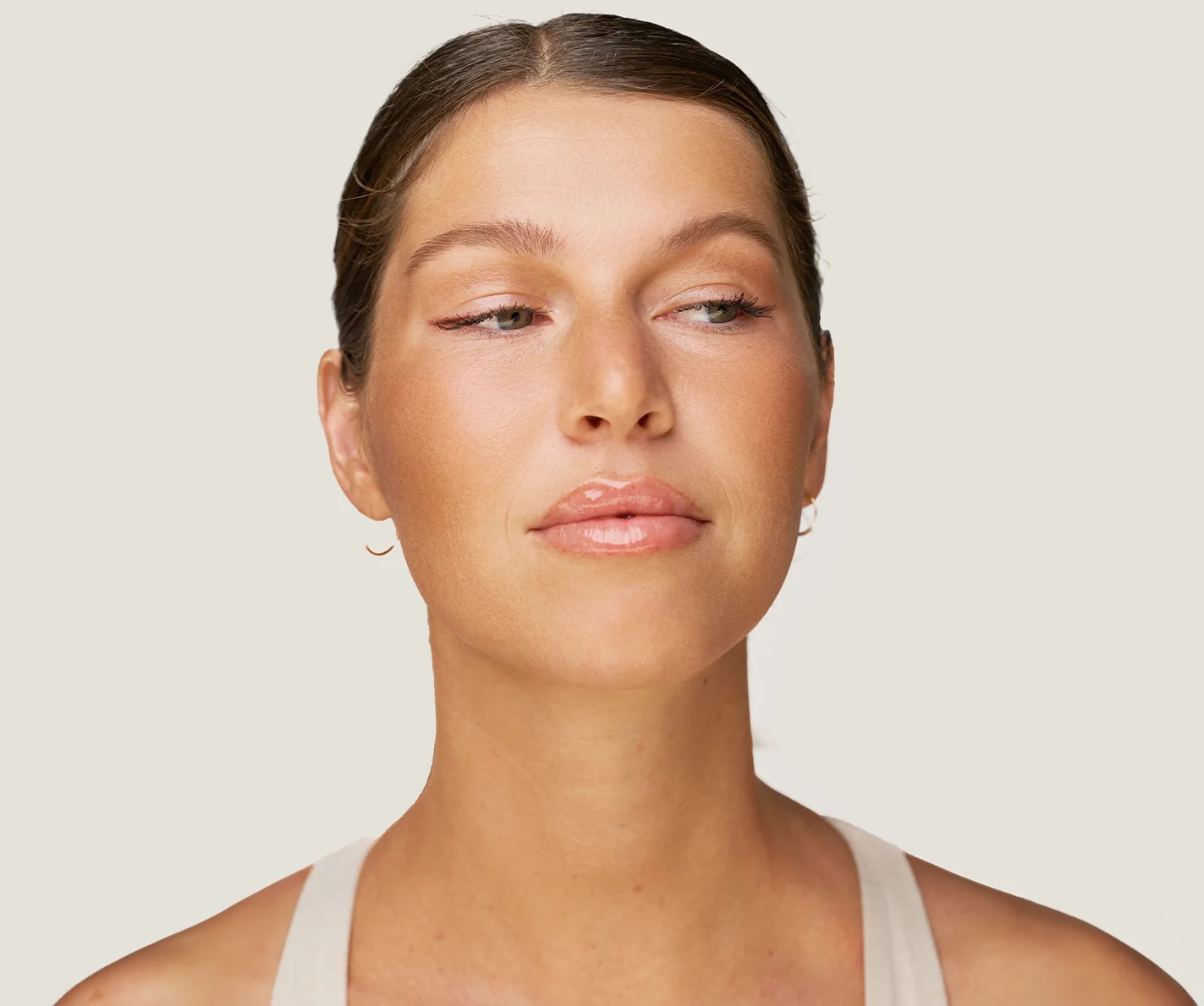 Young woman with smooth, radiant skin and no visible fine lines or wrinkles. 