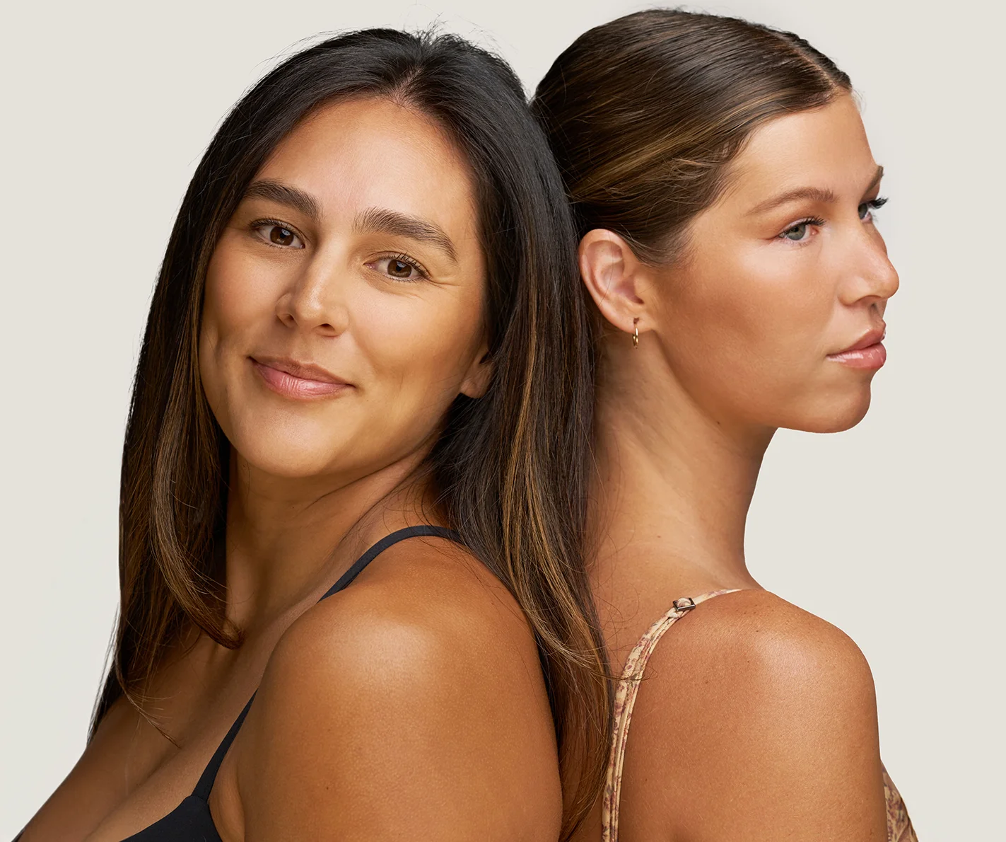 Two young women with youthful, refreshed skin and natural-looking, fuller lips. 