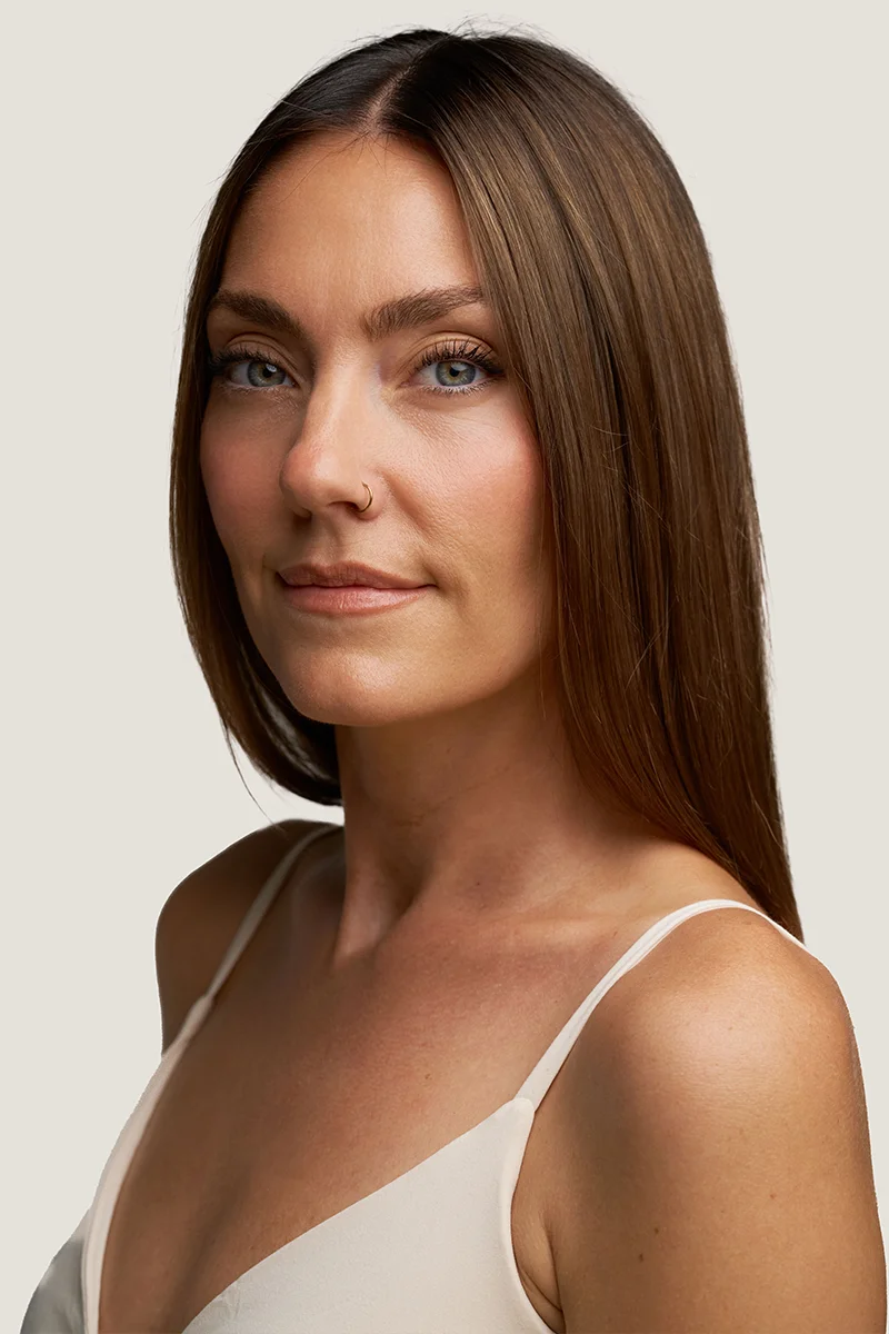 Young woman receiving a custom peel on her face and lower neck area. 