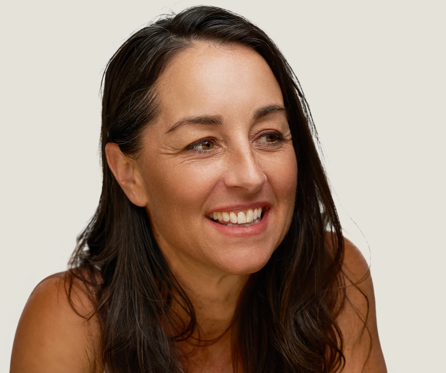 Middle-aged woman with radiant skin that is free of any fine lines or age spots. 