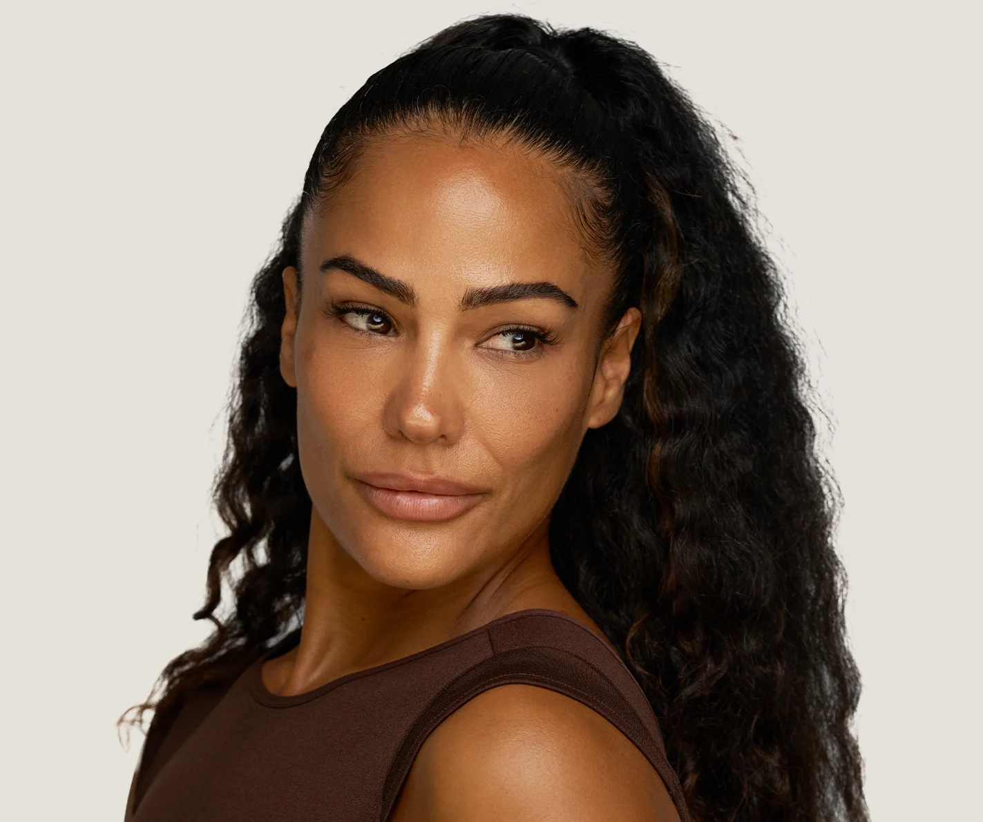 Young woman with plump, balanced skin and defined lip contour. 