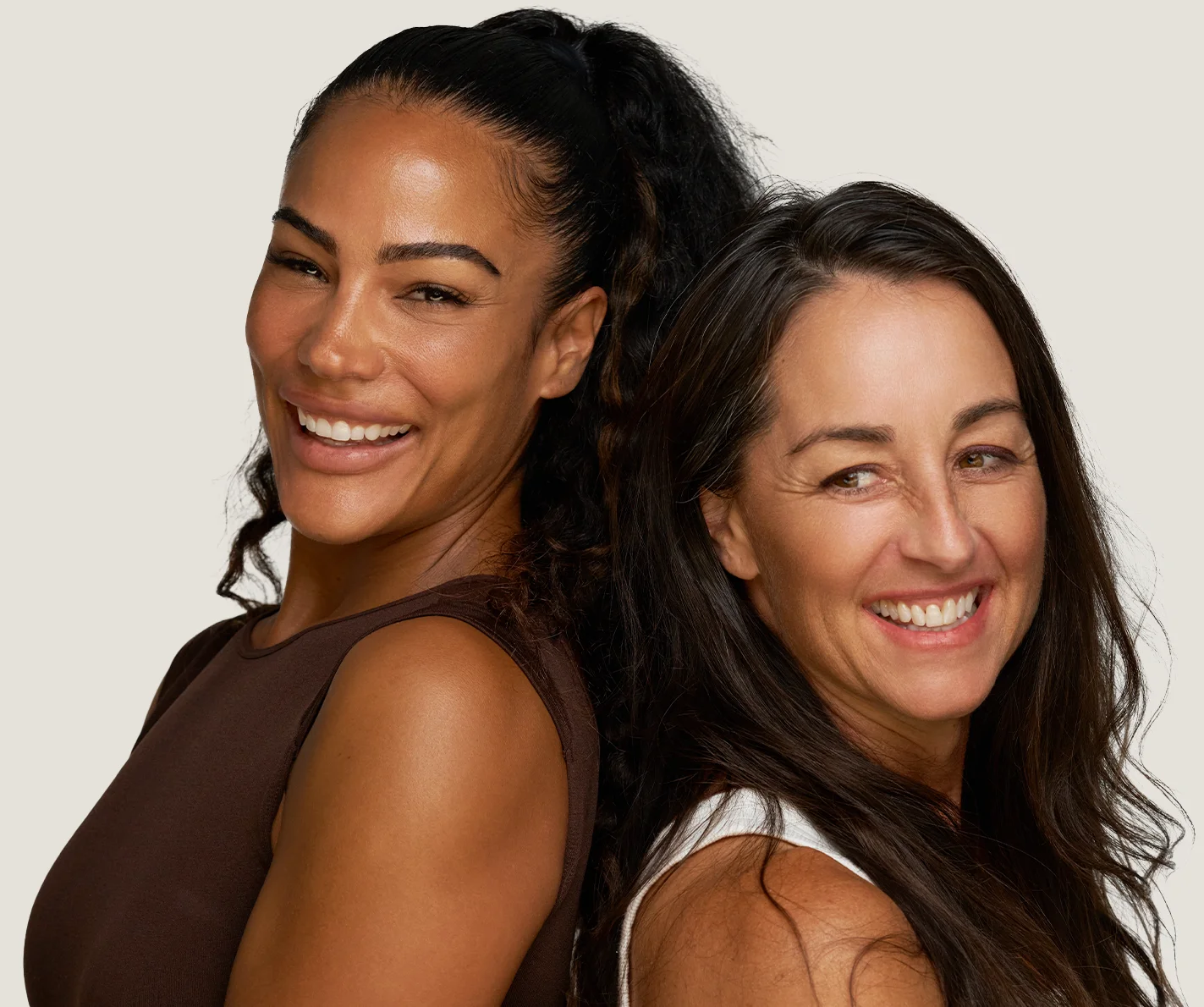Two women with smooth skin with no visible signs of aging or scarring. 