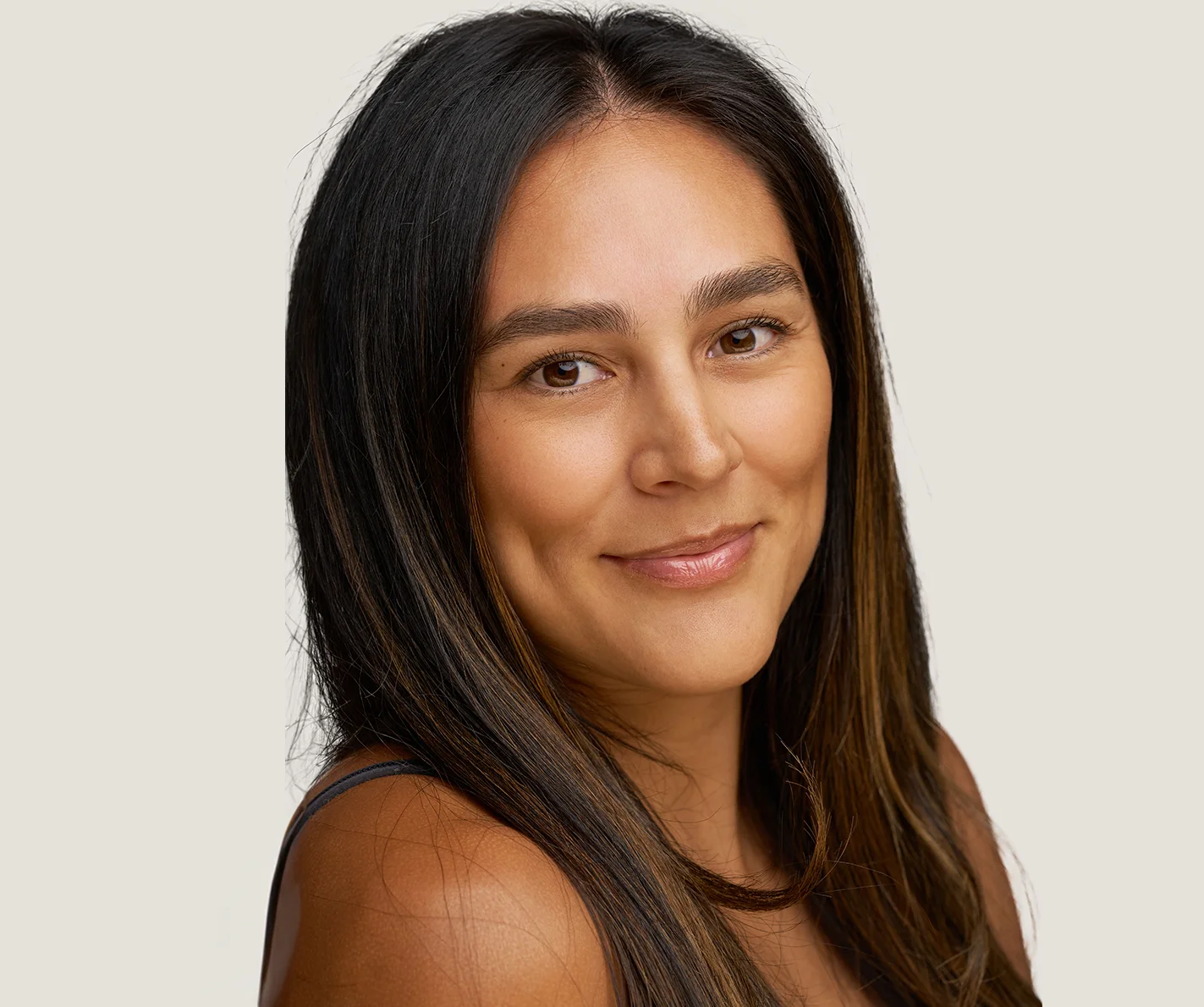 Young woman with skin that is radiant and even, free of scars or visible fine lines. 