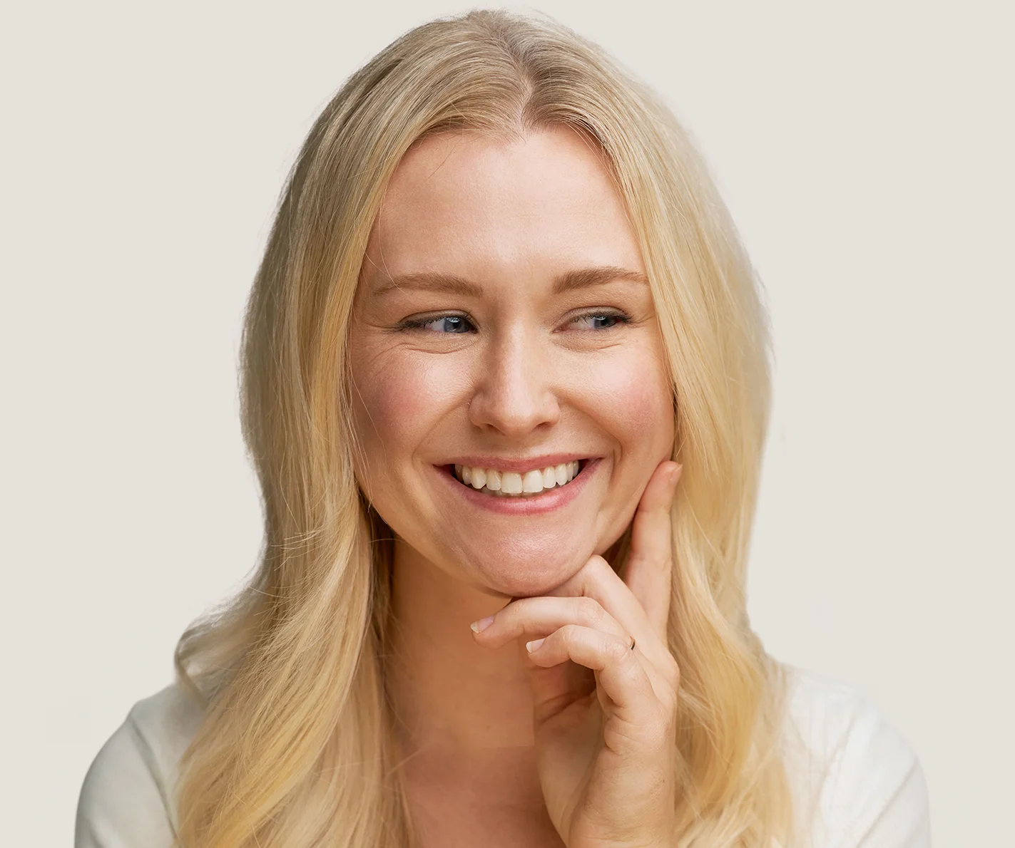 Young woman with radiant, glowing skin that has noticeable blemishes or acne breakouts. 