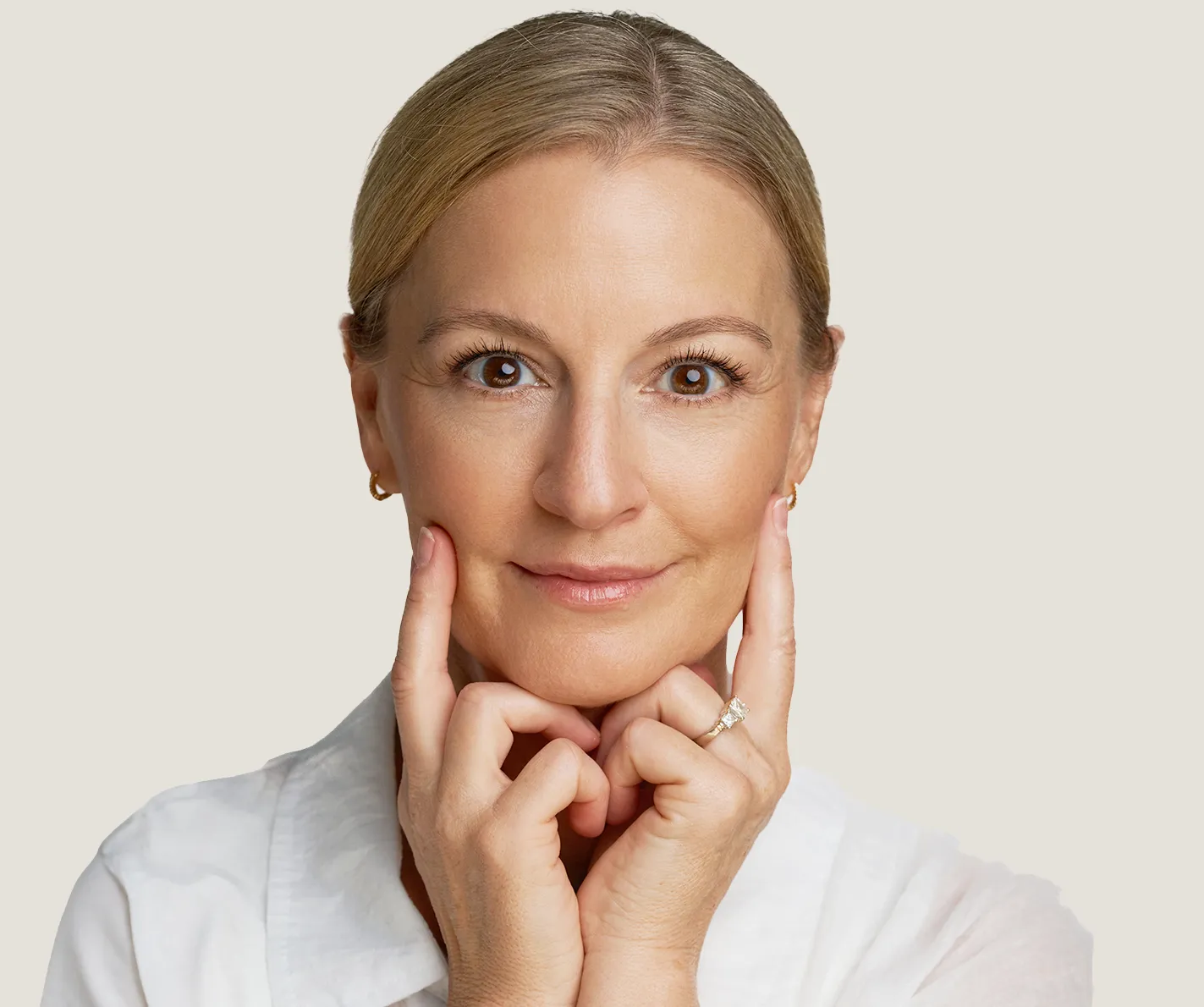 Middle-aged woman with youthful skin with no visible age spots or sun damage. 