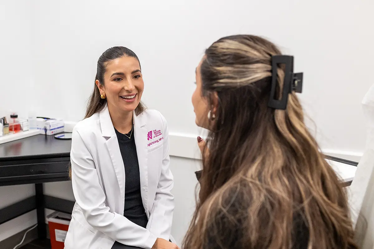 Young woman receiving a consultation from provider Ingrid Krong. 