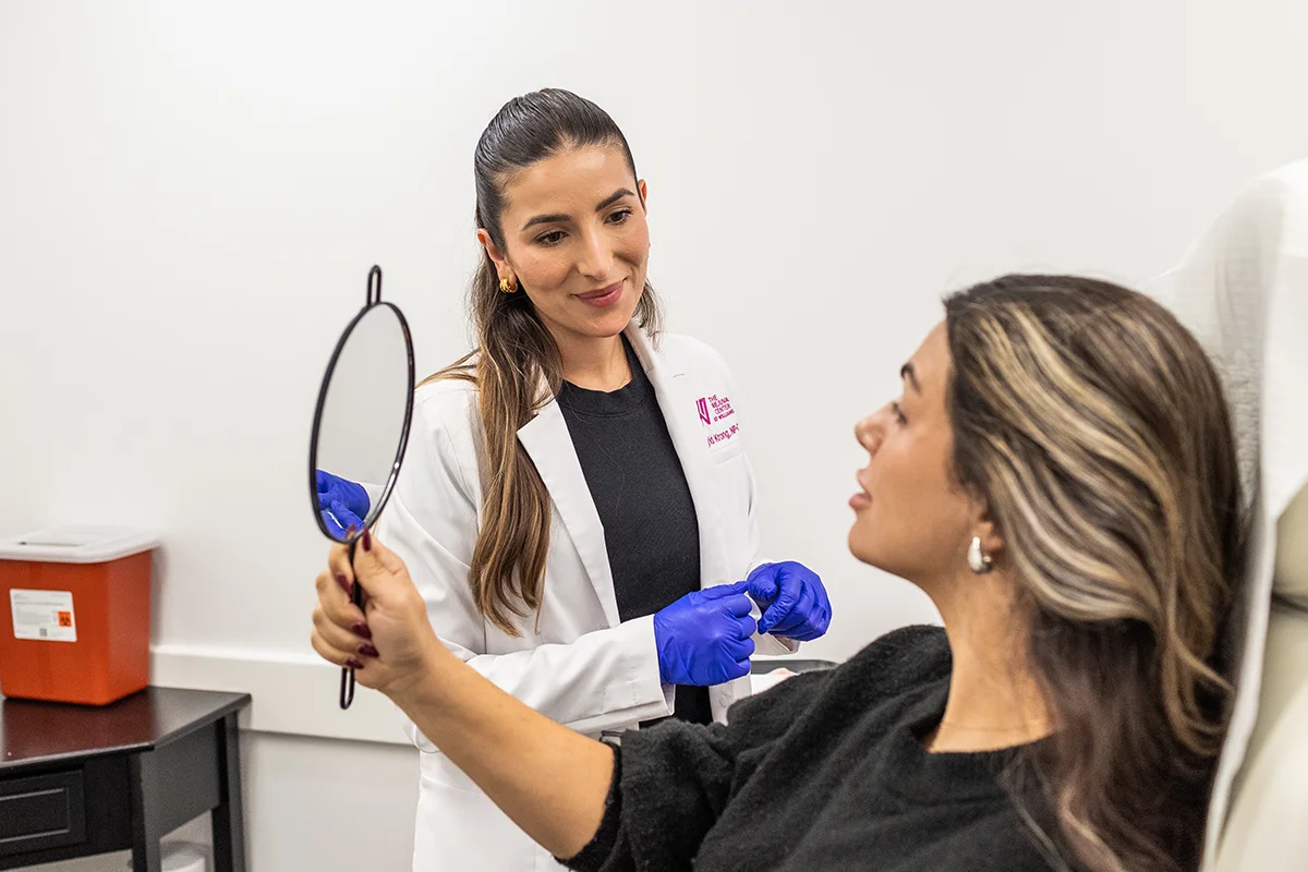 Young woman receiving a consultation from provider Ingrid Krong, going over concerns about her lips. 