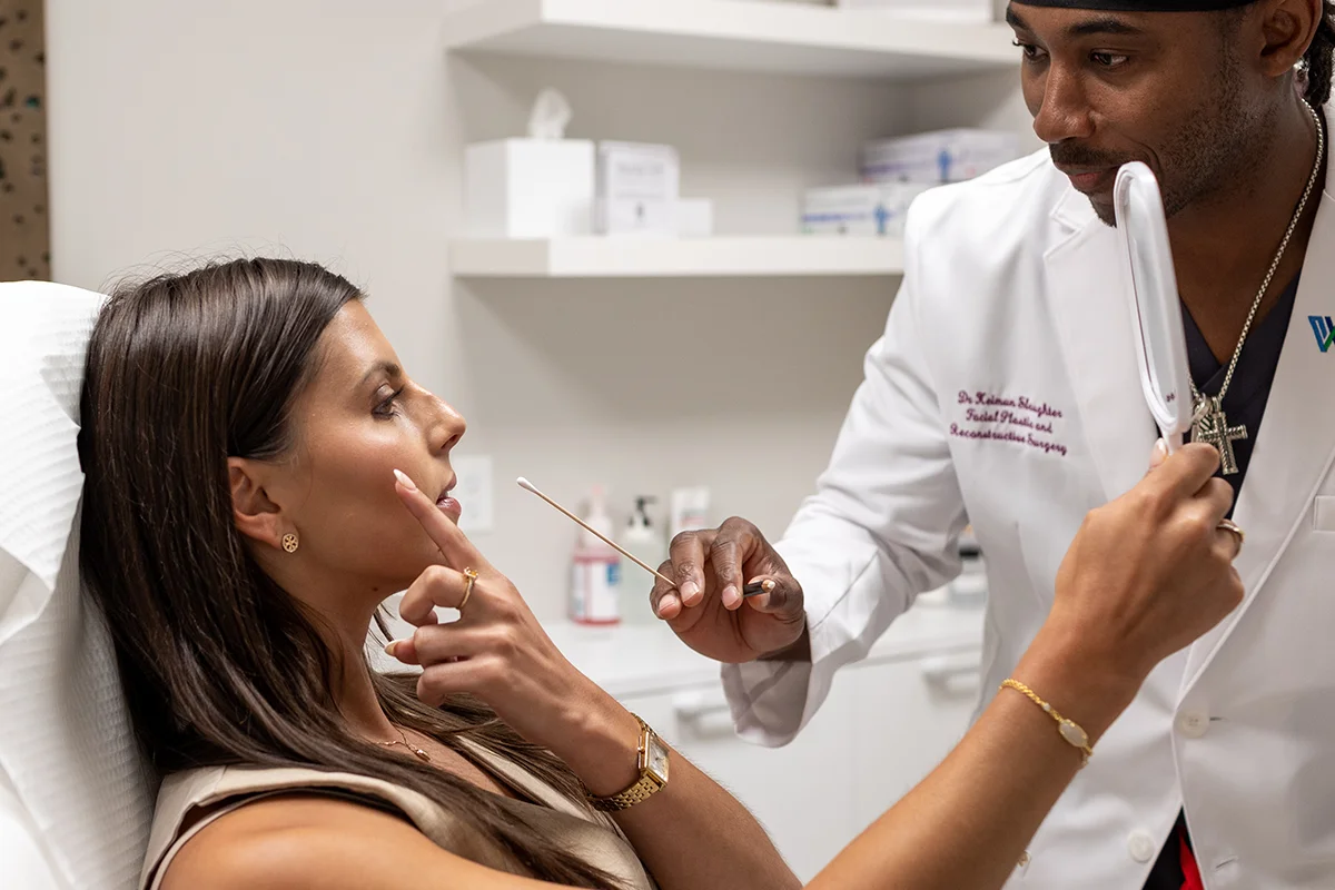 Young woman consulting with Dr. Keimun Slaughter, expressing concerns with her cheek volume. 