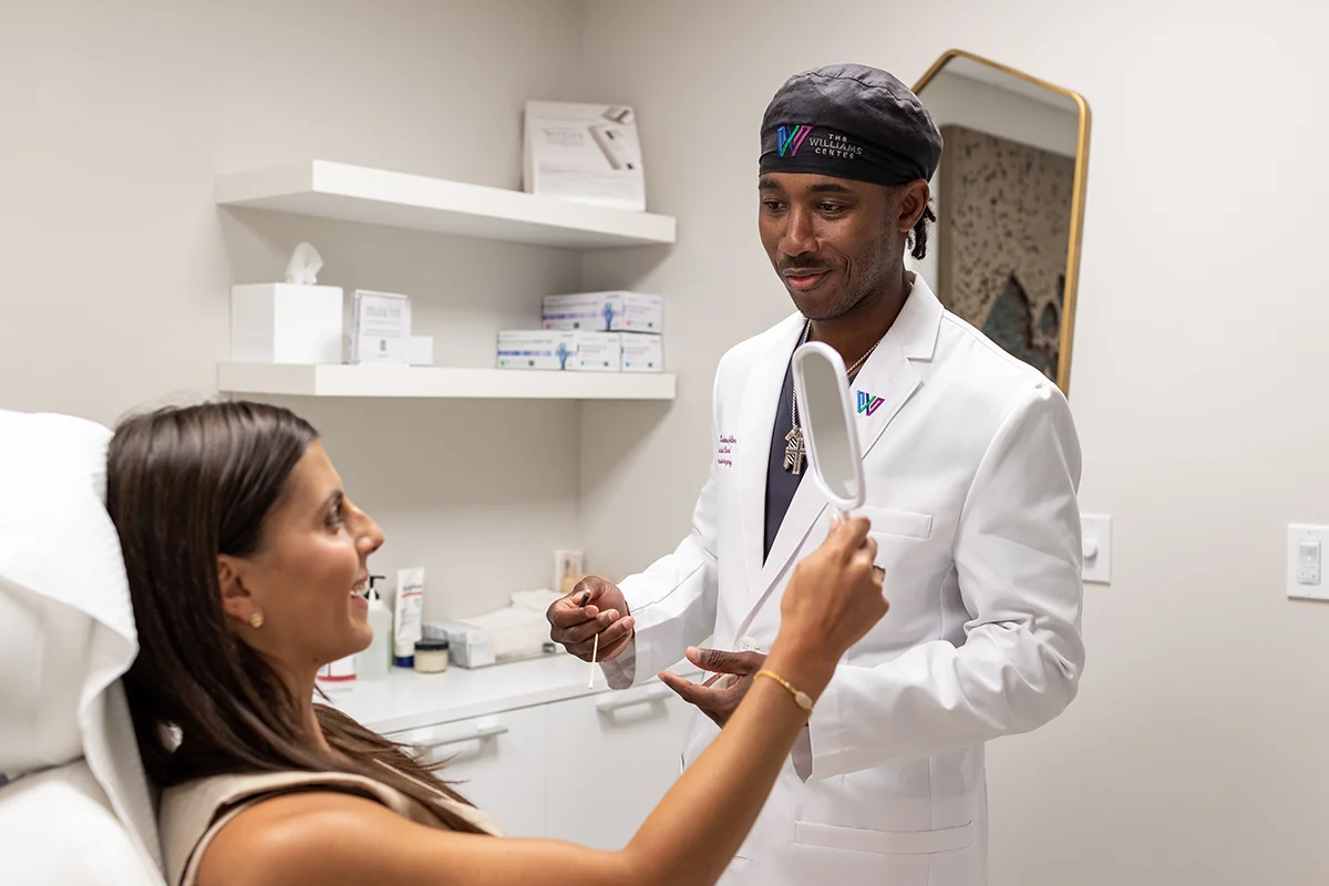 Young woman receiving a consultation from Dr. Keimun Slaughter. 