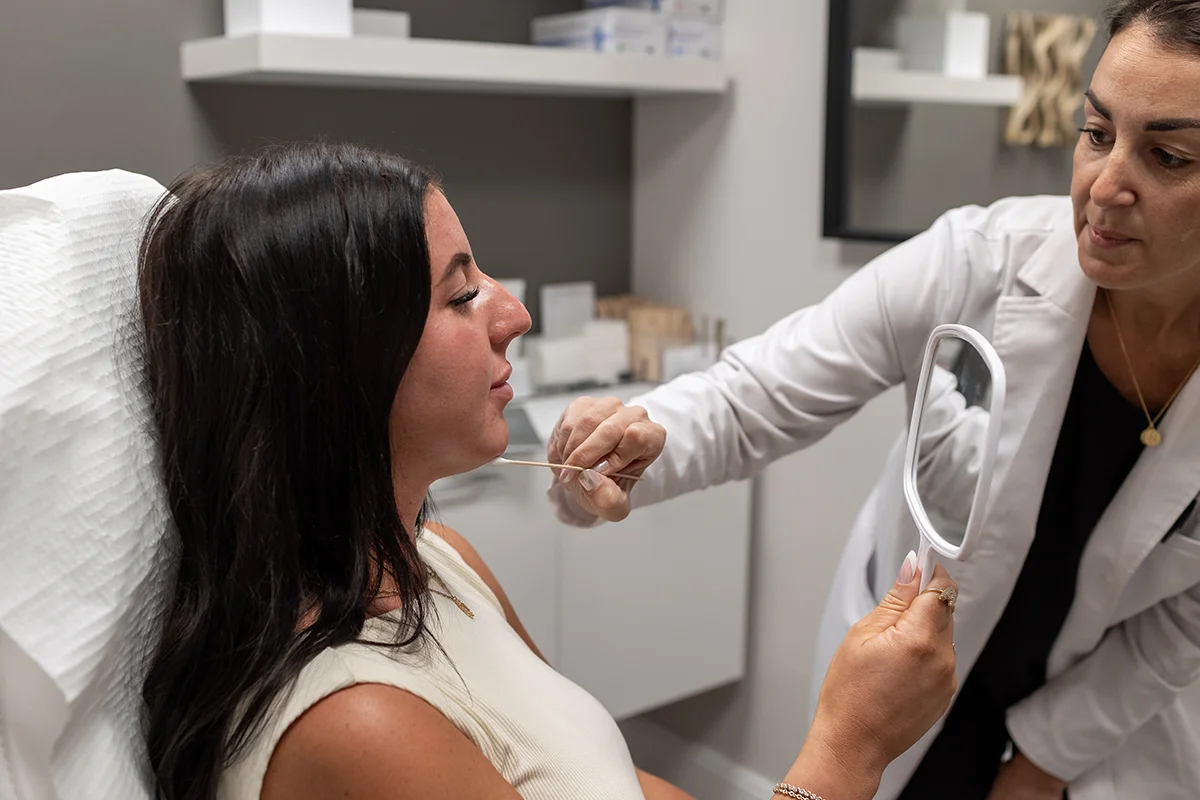 Young woman consulting with provider Andrea Lord, expressing concerns with submental fullness.