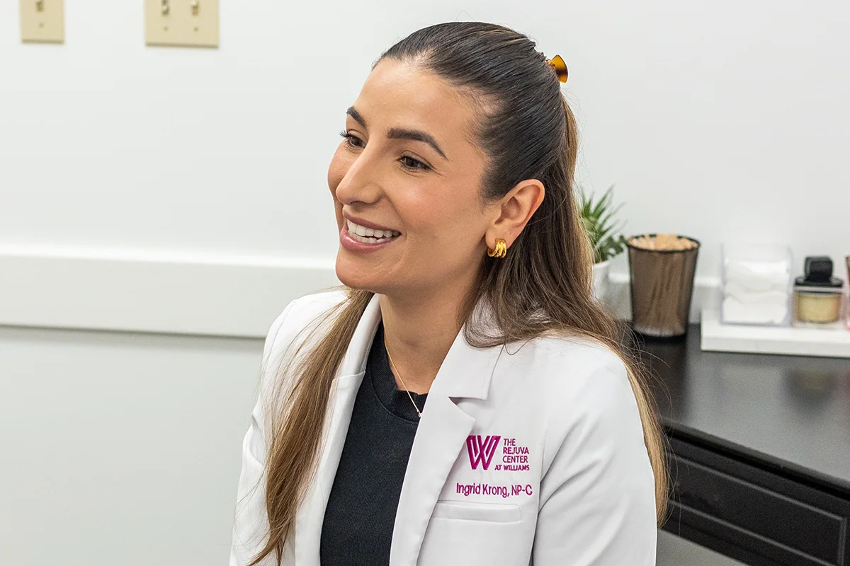 Provider Ingrid Krong having a consultation with a patient in a treatment room. 