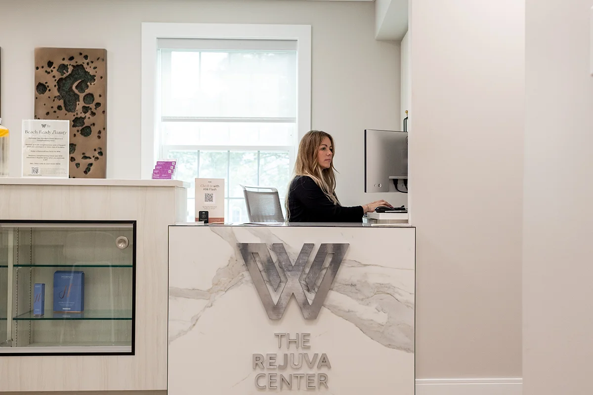 Young woman working the front desk of the Rejuva Center at Williams in Latham, NY. 