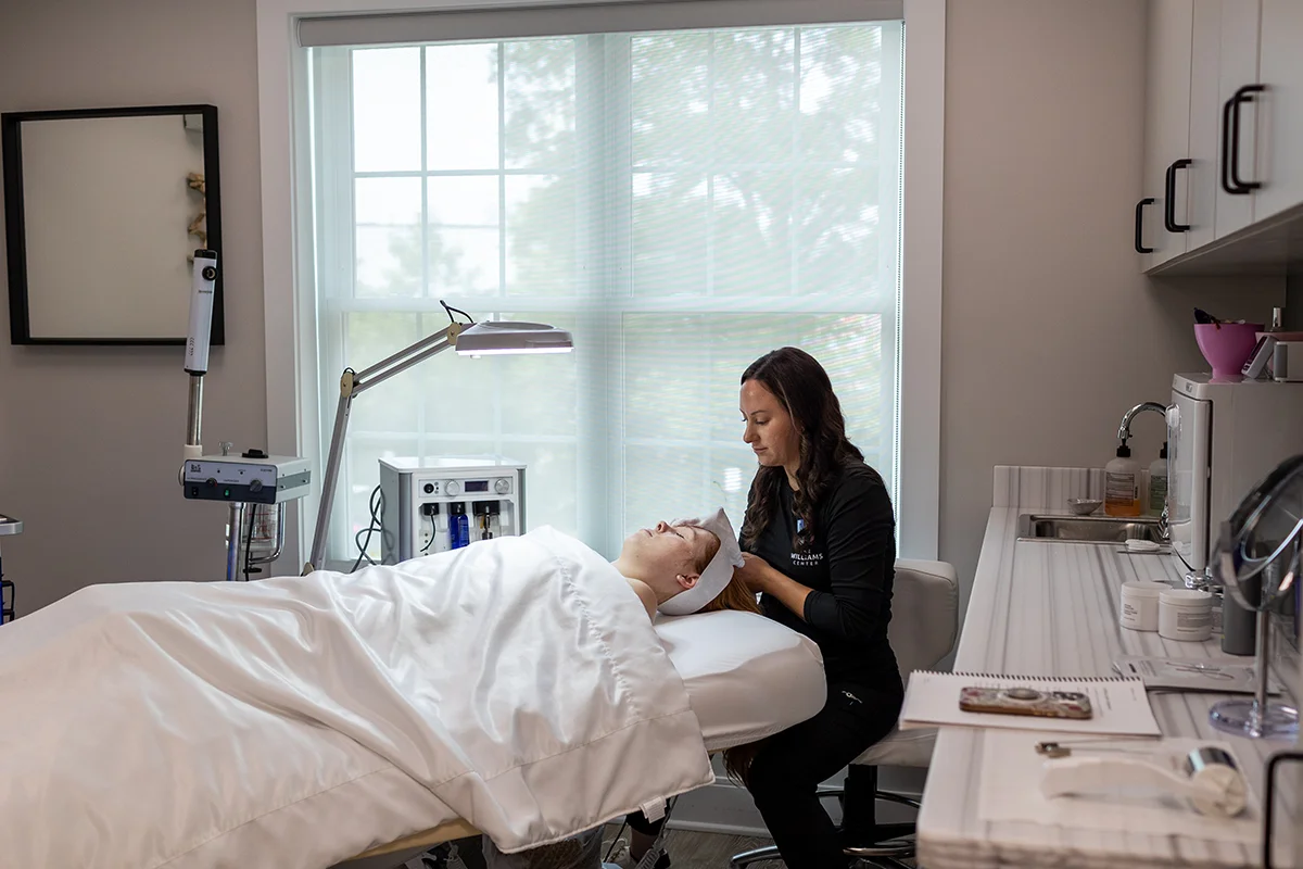 Young woman getting set up for DiamondGlow treatment with provider Angela Goodrich. 