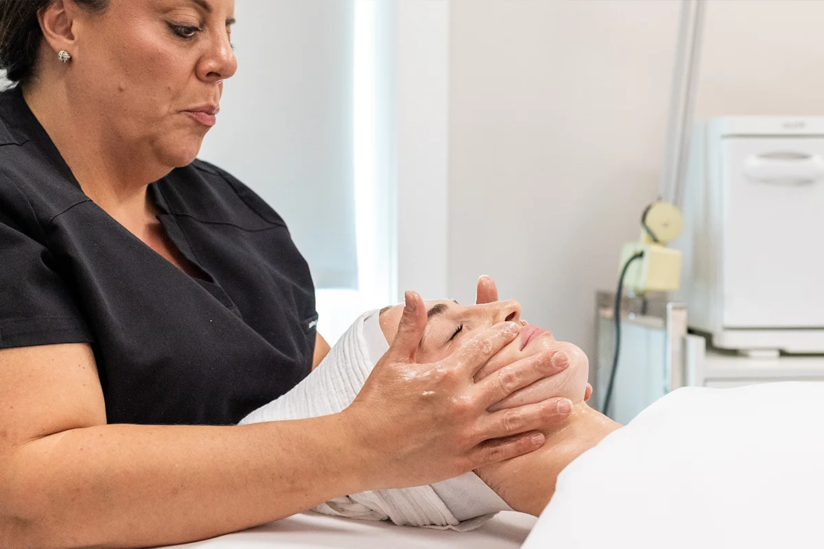 Young woman getting a custom facial treatment. 