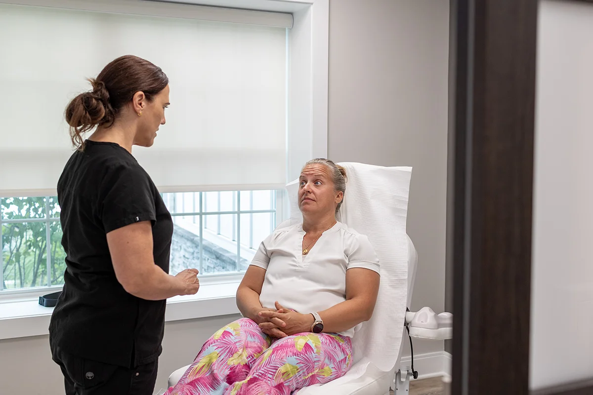 Middle-aged woman receiving a consultation from provider Lisa LeBlanc.