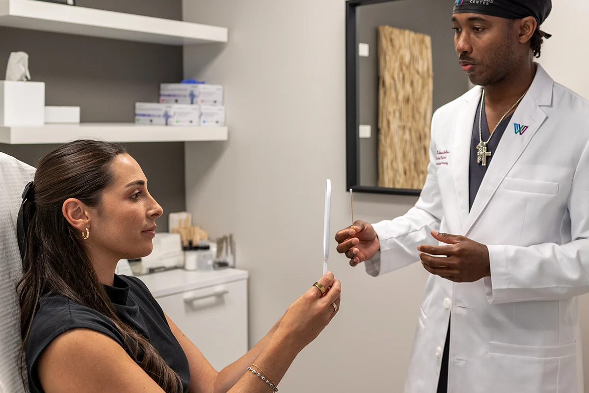Young woman having a consultation with Dr. Keimun Slaughter about her nose.