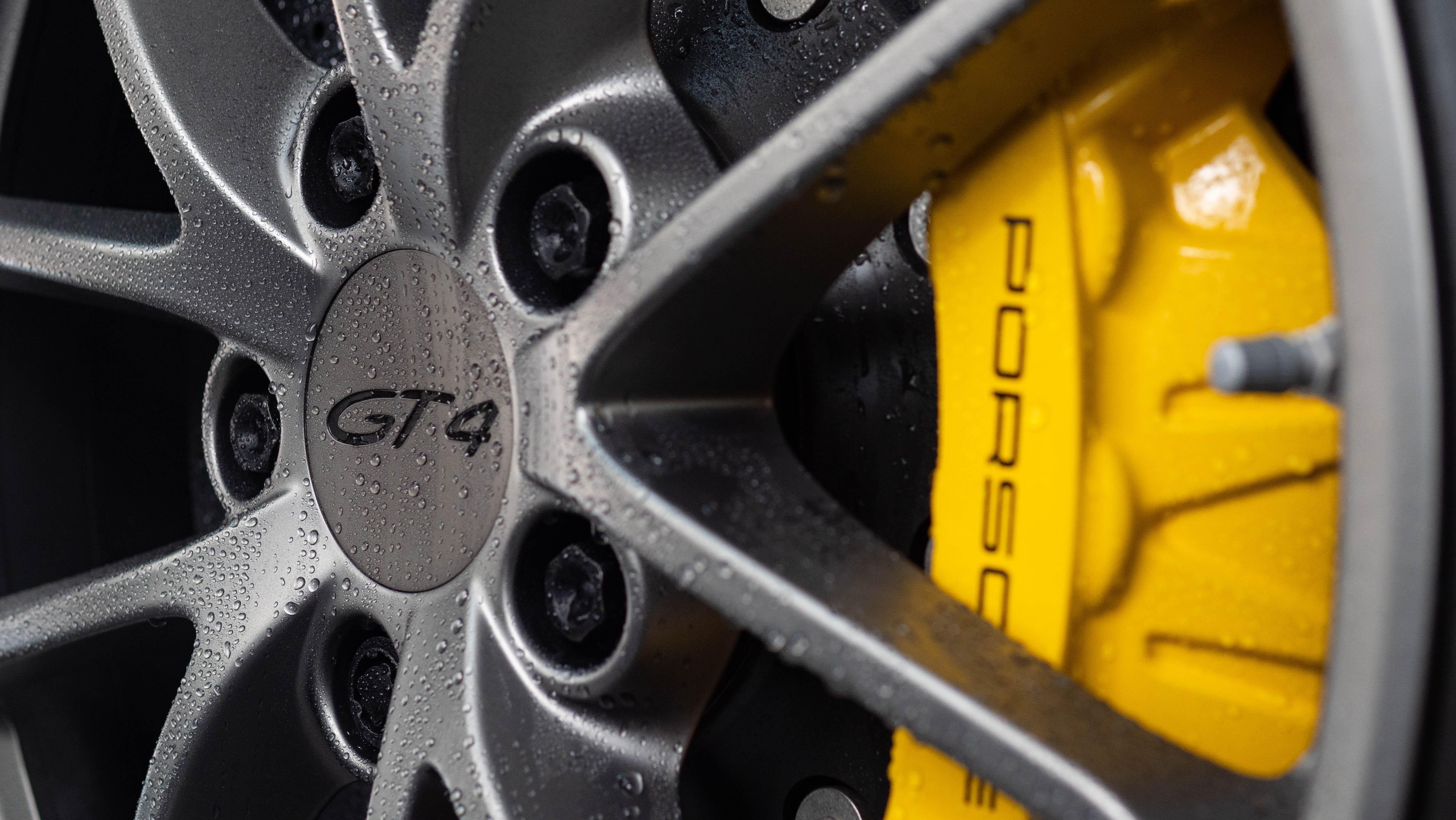 Porsche GT4 brake caliper beading water after Wax Is Dead ceramic coating, installed by Halo Collective