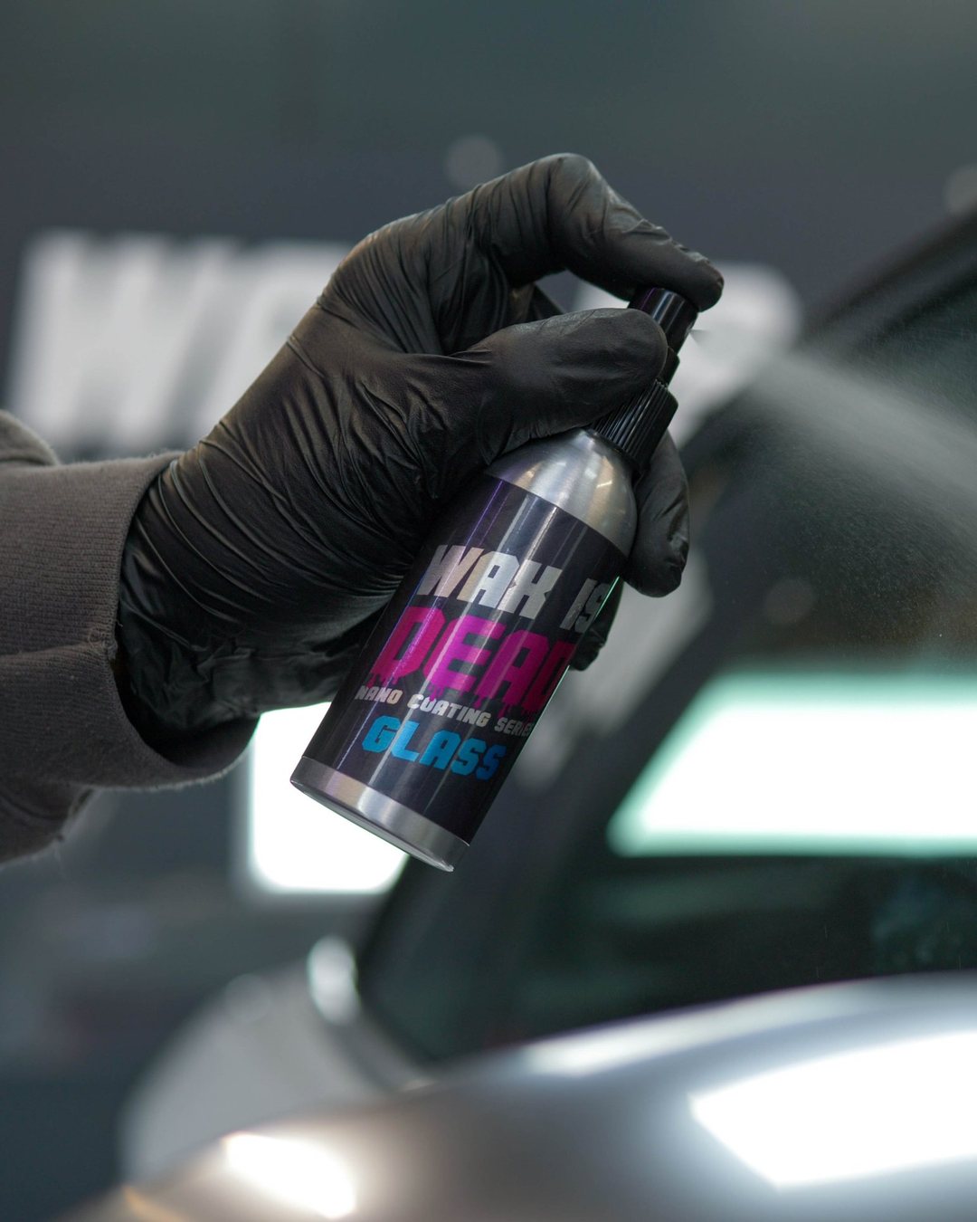 WID Glass coating being sprayed onto a car window