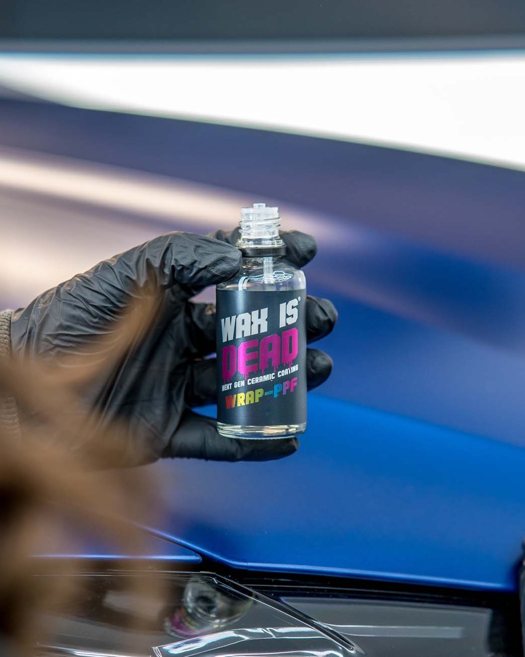 WID Wrap-PPF ceramic coating held over a film-protected bonnet