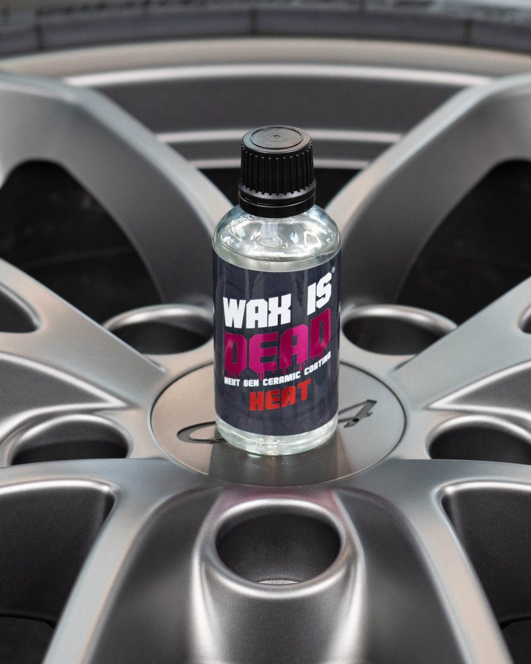 WID Heat ceramic coating bottle on an alloy wheel