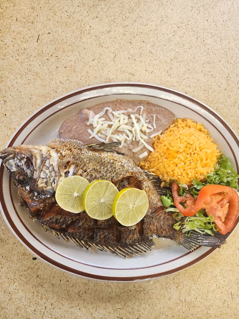 A plate of food with a fish on it.