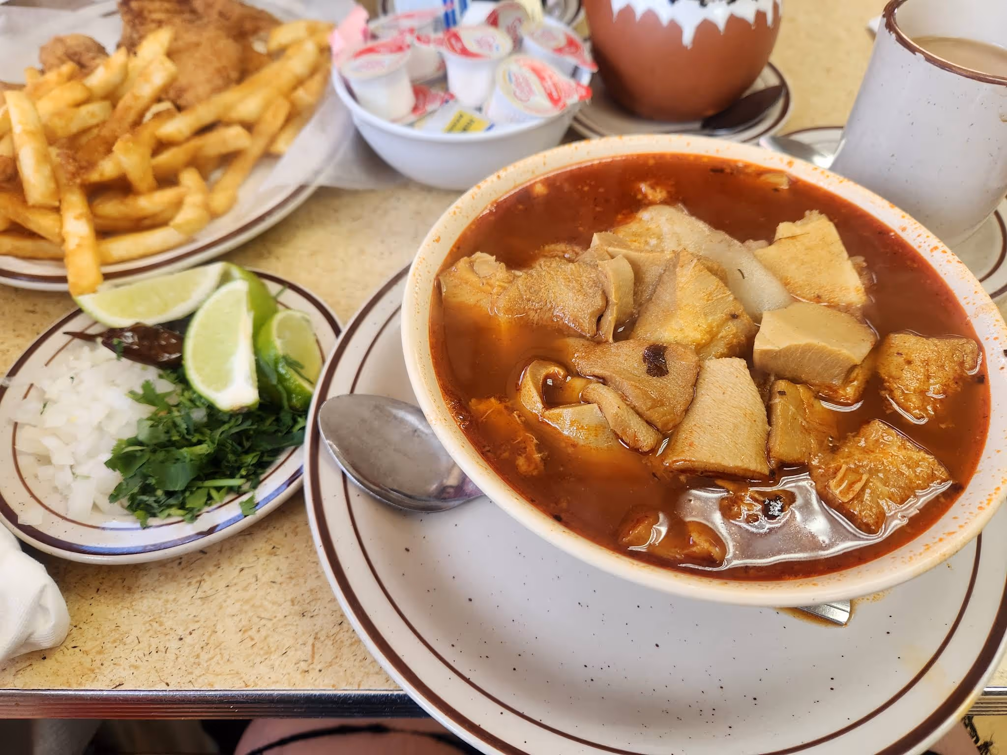 A bowl of soup with meat and vegetables.