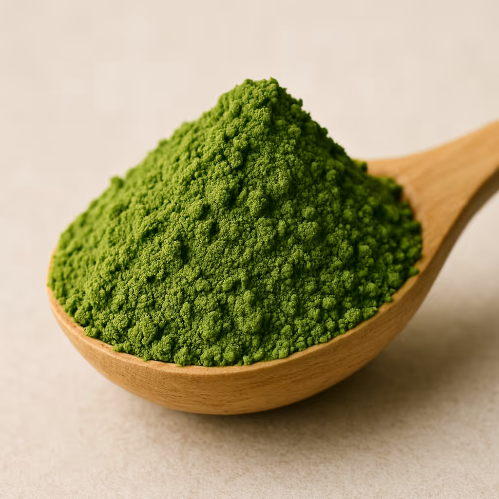 Close up of organic matcha powder on a wooden spoon