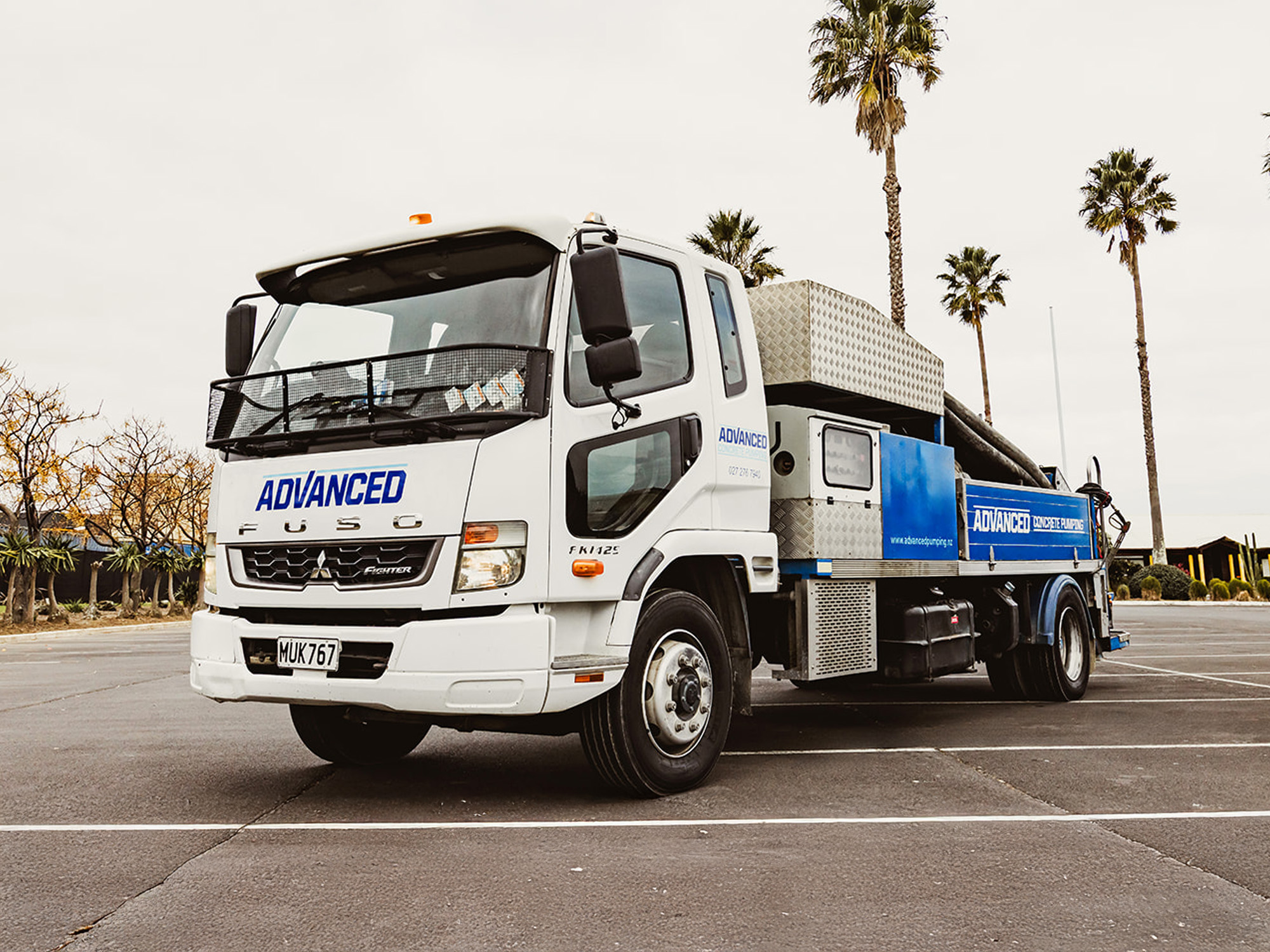 Advanced Concrete Pumping blue boom pump truck on a construction site in Te Arai, New Zealand.