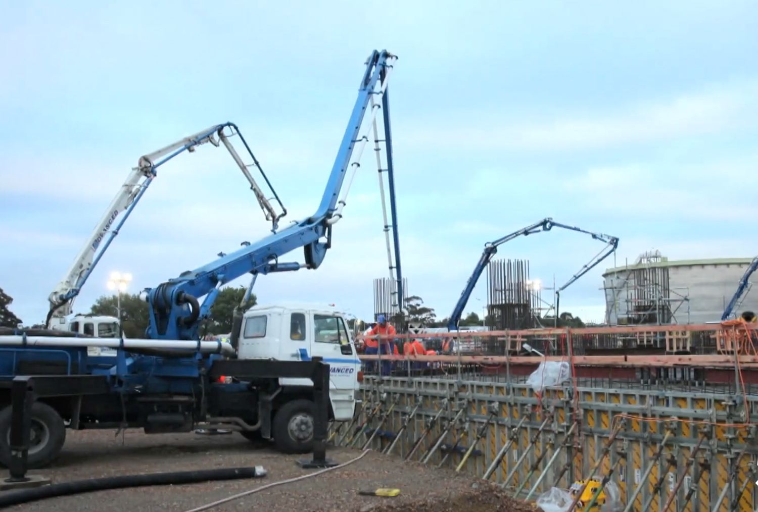 Advanced Concrete Pumping boom trucks on site at Marsden Point Oil Refinery, placing concrete into reinforced foundations during major industrial project works.